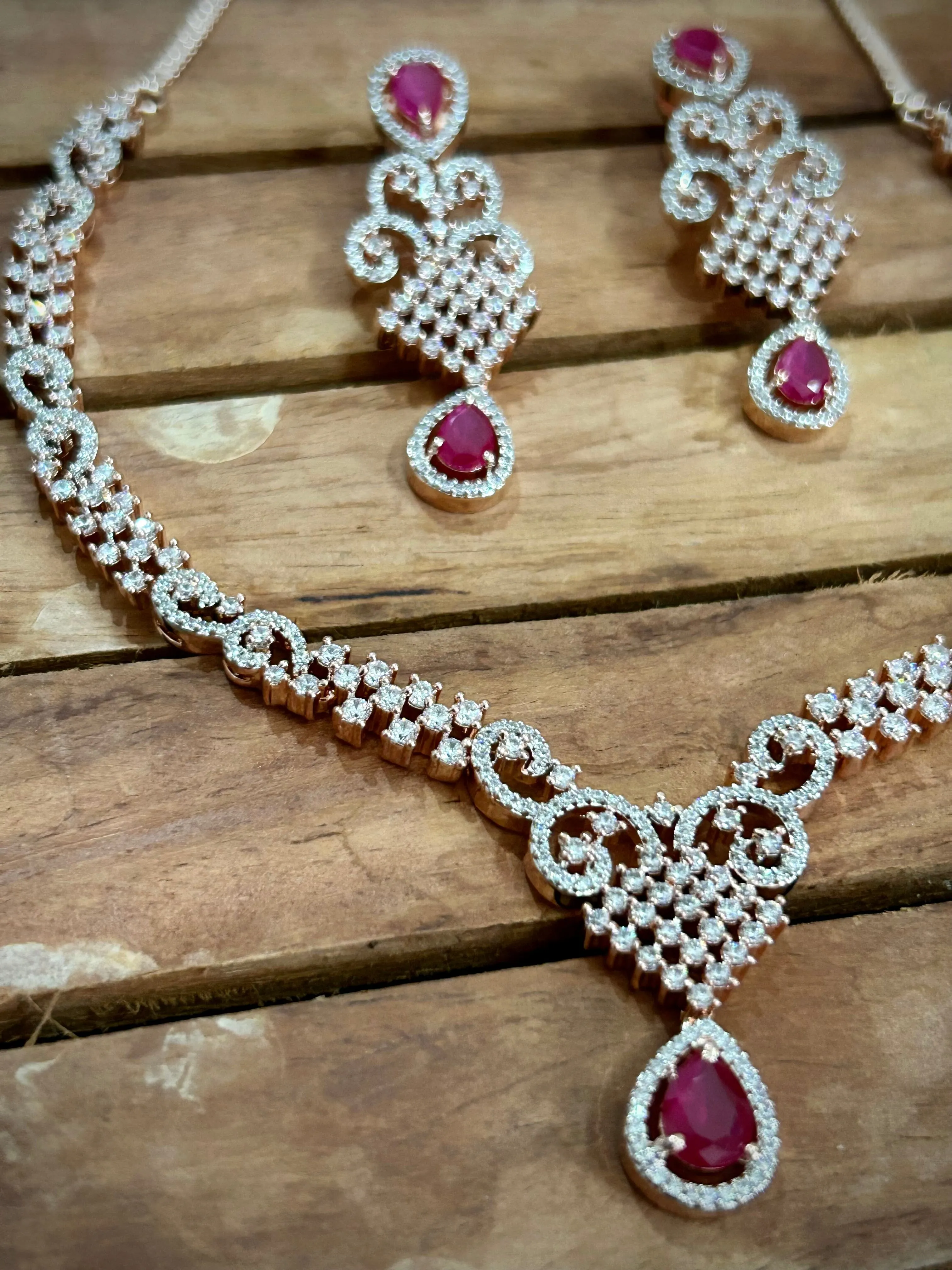 7. Pink American Diamond necklace with pink stones and rose gold polish
